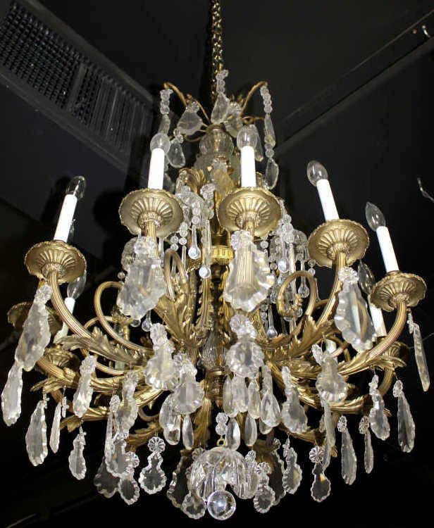 Twelve Arm Bronze and Crystal Chandelier: Height approximately 39 Inches Width approximately 24 Inches