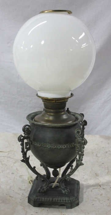 Bronze Table Lamp: Bronze base with four volute and leaf handles. Height approximately 23.5 Inches. Diameter approximately 10 Inches