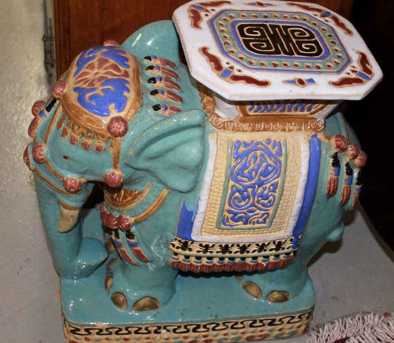 Standing Painted Elephant Garden Seat: Standing blue elephant, with headdress and decorative saddle. Height 21 Inches Width 9.5 Inches Depth 16 Inches