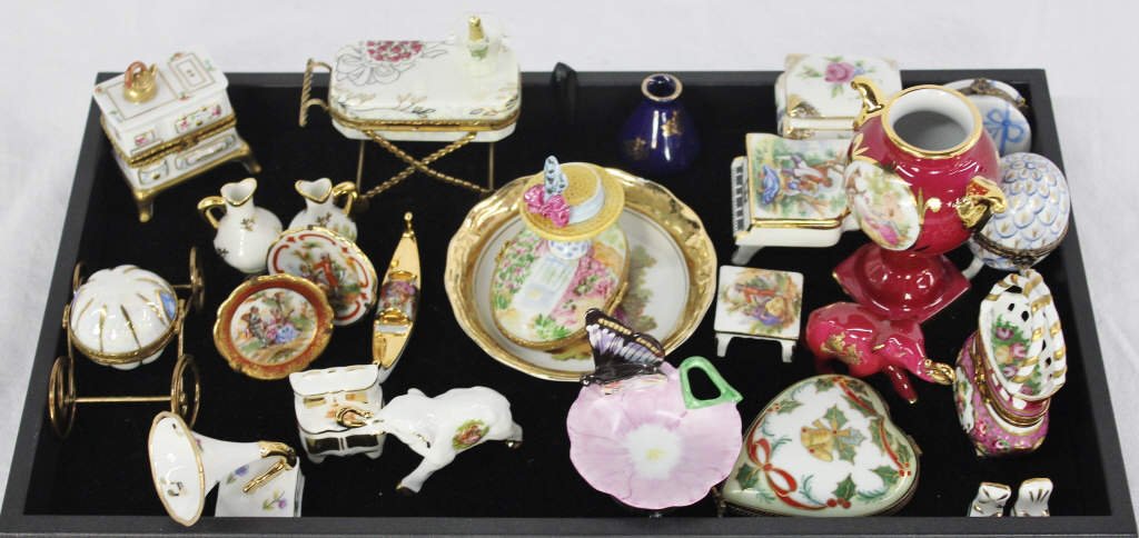 Group of 25 Assorted Limoges Miniatures: Includes two small purse boxes, one heart shaped Christmas box, three miniature plates, a stove and hutch, a champagne buffet table, a piano, a phonograph, magenta elephant and vase, two small blue va