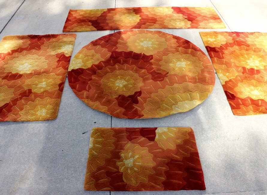 Five Assorted Momeni Custom Carpets: One round, one long, two wide, one small, all with red, yellow and orange pattern Largest Length 84 Inches Width 30 Inches Round Diameter 68 Inches From a home in Irvington NY Pair Length 65.5 Inches 