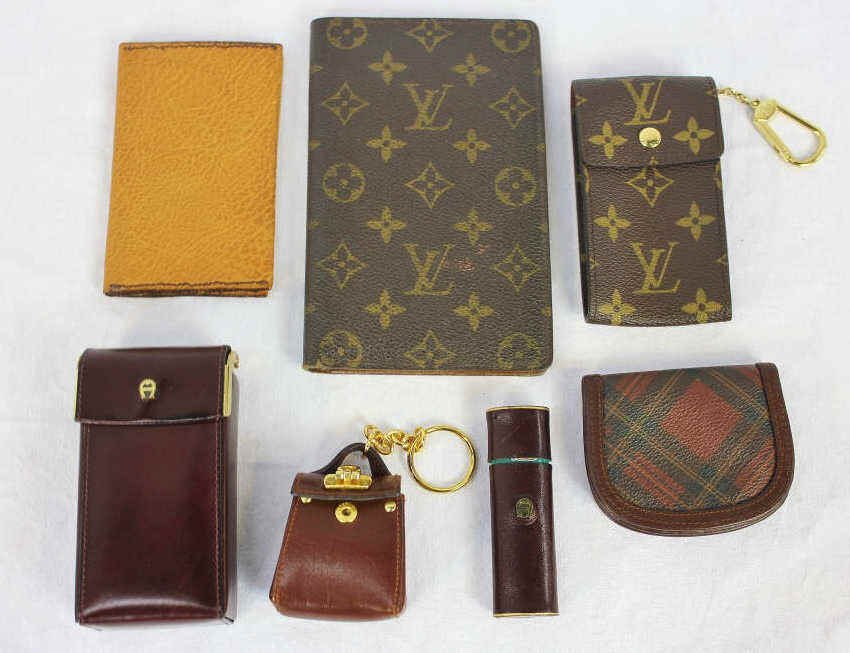 Group of Designer Wallets and Cigarette Cases: Property of a Westport, CT estate Includes burgundy color Etienne Aigner cigarette case and lighter, Ralph Lauren plaid change purse, Louis Vuitton credit card holder and cigarette case, and Salvatore
