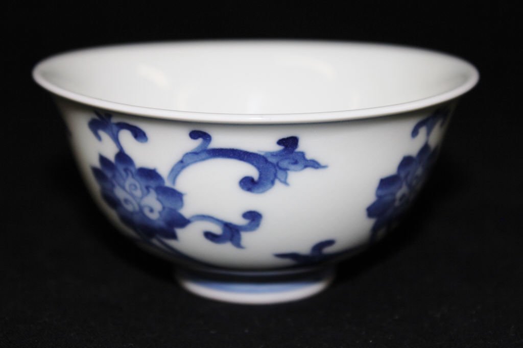 Antique Chinese Blue and White Cup: Marked on the bottom. Floral design. Height 2 Inches Width 4.5 Inches