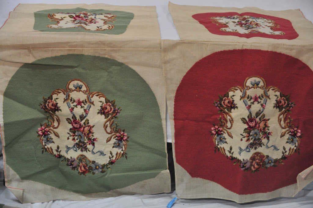 Twelve Needlepoint Seat Covers: Eleven green and one red.