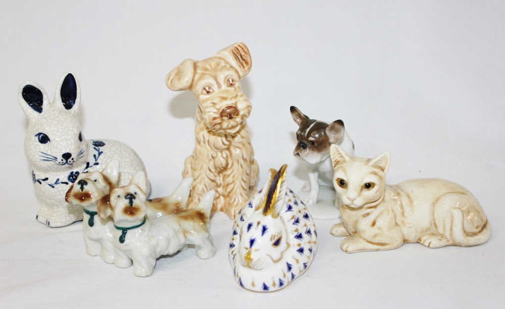 Group of Porcelain Animal Miniatures: Includes a Royal Crown Derby Bone China rabbit and a Rosenthal dog. Two rabbit porcelains, three dog porcelains, and one cat. From an estate in Mamaroneck, NY Tallest Height 5 Inches.