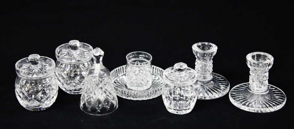 Assortment of Cut Glass Articles: Two candle holders, a bell, three lidded bowls, a small cup, and a dish. Height of bell 6 Inches Width 3 Inches