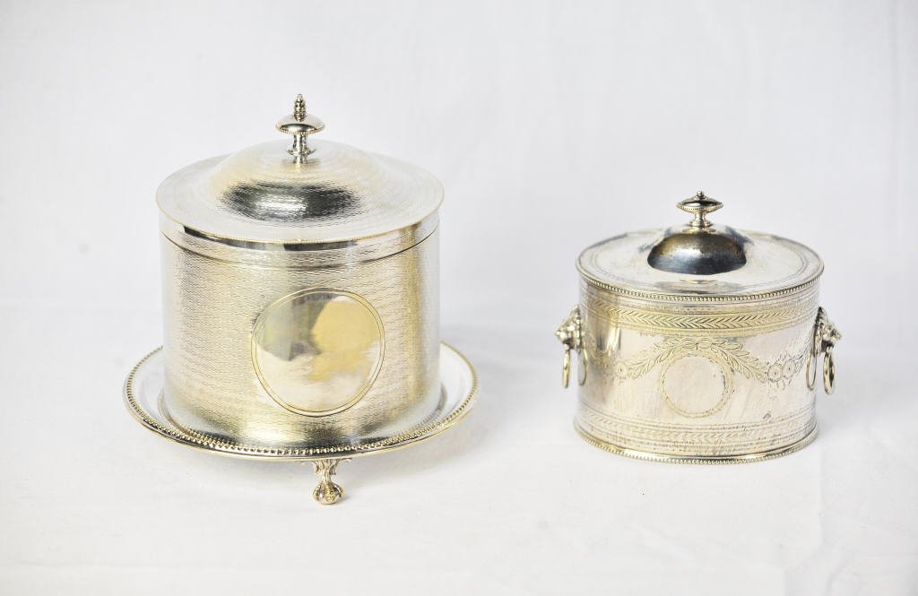 Two Silver Plate Tea Caddies: English tea caddy with two lion mask ring handles Made in Sheffield, Circa 1875 by Mappin Height 5 Inches, width 5 Inches depth 4 Inches Height 8 Inches Diameter 7 Inches