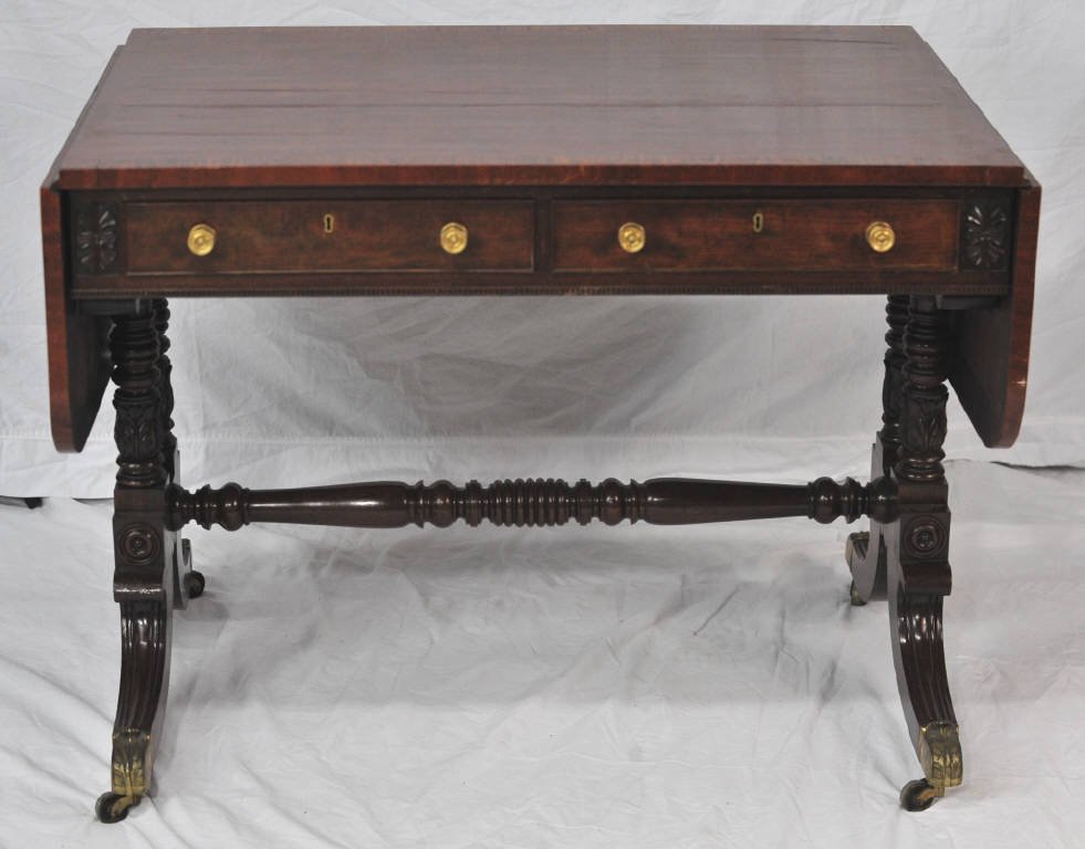 English Regency Sofa Table Circa 1825: Two drawers, two drop leaves. Scrolled legs. Height 29 Inches Width 37 Inches Depth 26.5 Inches