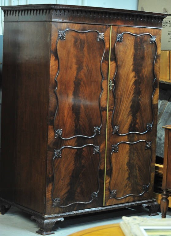 Antique Old English Armoire with Brass Fittings: Six refitted drawers inside, carvings on front with dentiled cornice. With key. Height 77.5 Inches Width 50.5 Inches Depth 31.5 Inches