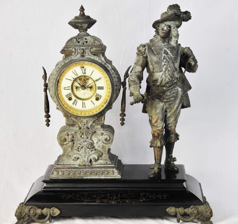Bronze and Marble Ansonia Mantle Clock: Bronze clock and accompanying sculpture of man with sword, on marble base. Height 22 Inches Width 19.5 Inches Depth 9 Inches