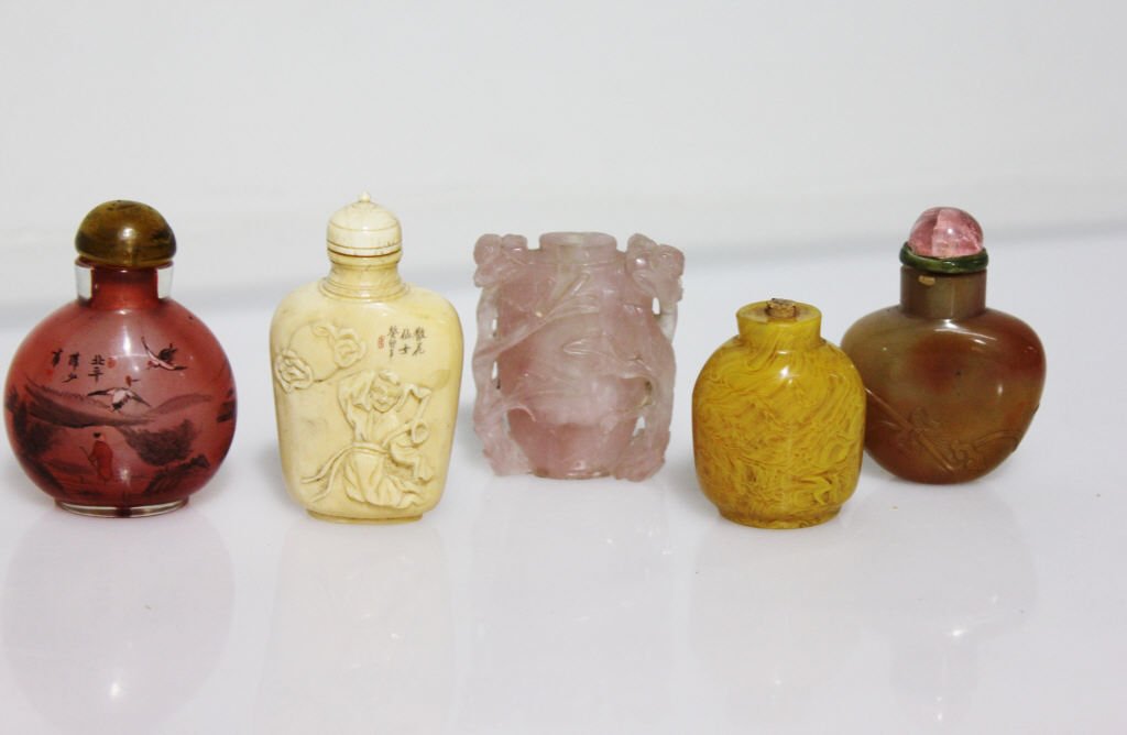 5 Antique Snuff Bottles: One Carved Bone Snuff Bottle, Pink Quartz, Glass Excellent Condition, no chips or breaks. Height: 3 inches. Width: 1.5 inches. One Mustard Glass Snuff Bottle with cork/reed but missing cap. No chips, 