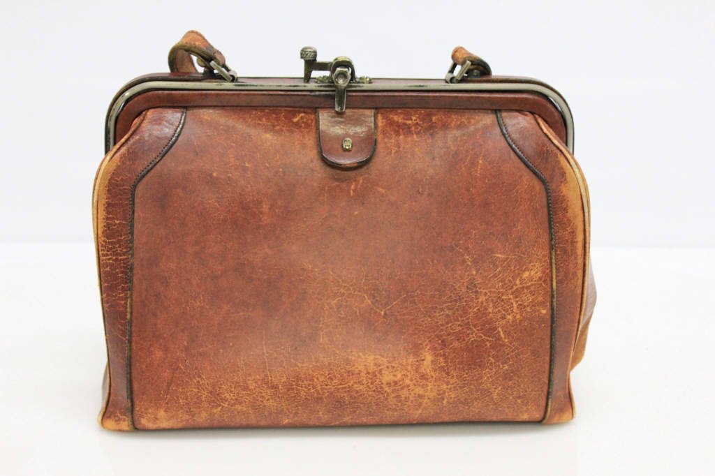 Vintage Etienne Aigner Cognac Leather Doctor Bag: Distressed. With (faded) gold-hardware. Height: 9 inches. Length: 11 inches. Depth: 4 inches.