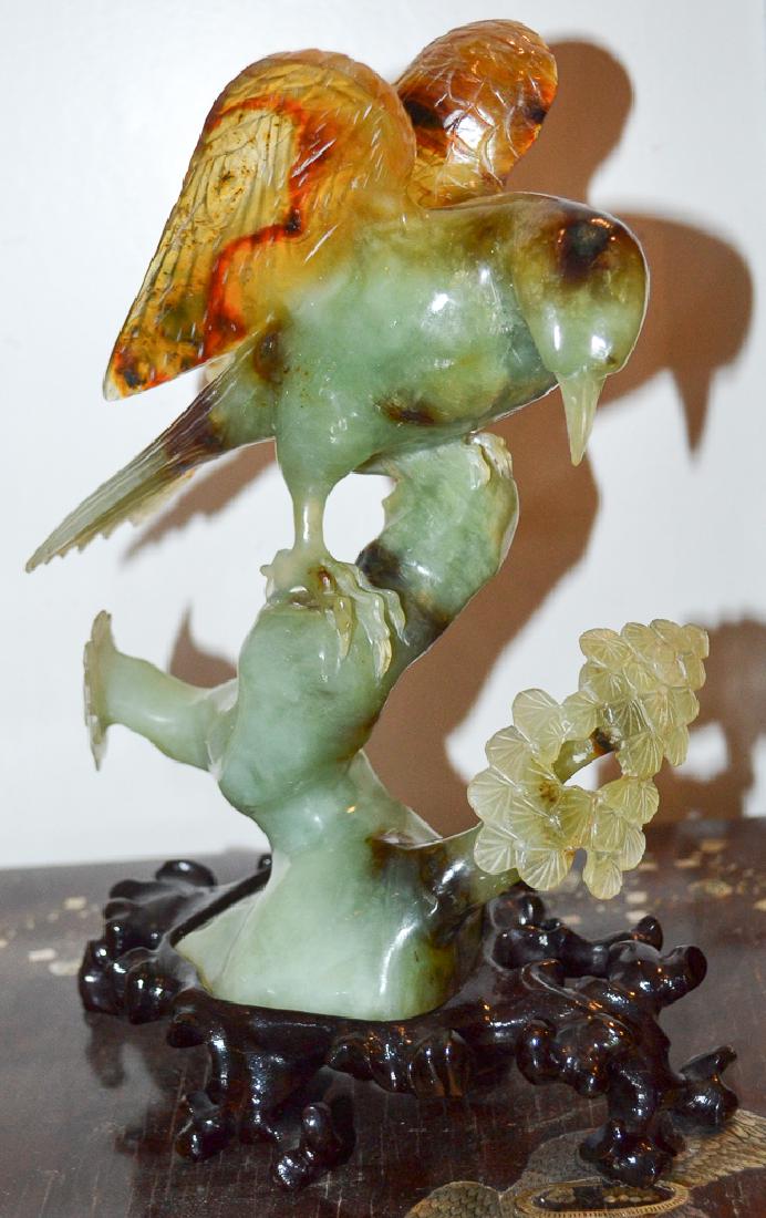 Jade Bird Figurine: In Dimensional Form, Hand Carved, Fine Detail, Bird On Branch , Wood Stand. Beautiful Movement, Excellent Coloration Of Jade With Variations. Size: 12" H X 7" W X 5" D. Condition : Excellent.