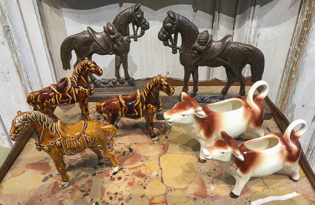 7 Decorative Pieces, Cows & Horses.: 2 German Cow Creamers, 3 Chinese Glazed Tang Horses, And A Pair Of Iron Horse Doorstops. 7 High. Good Vintage Condition.