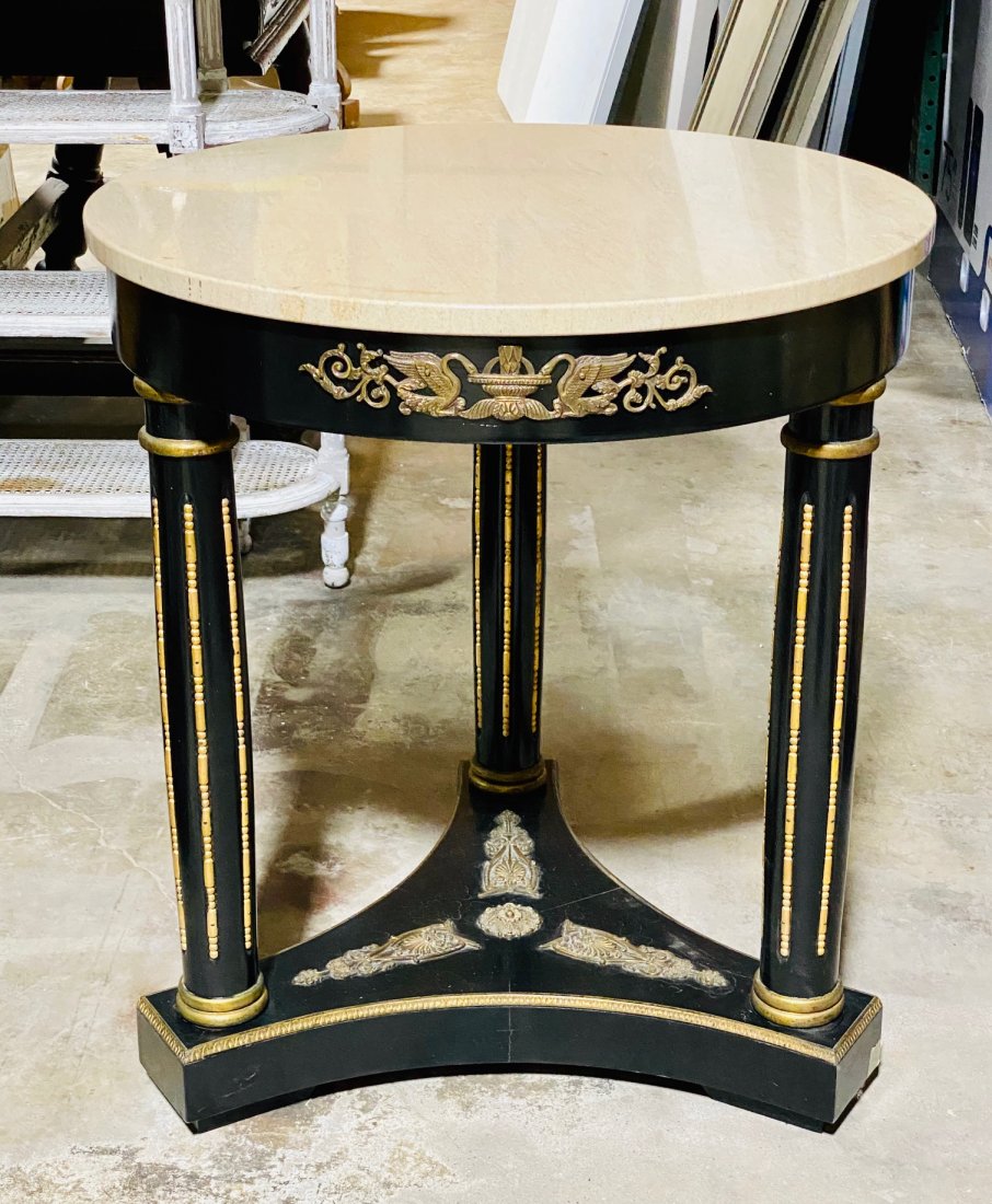 An Empire Design Round Table, Ebonized Finish: with bronze mounts, 20th c, 24 dia x 27.5 h. See photos for good condition and one spot of loss at foot.
