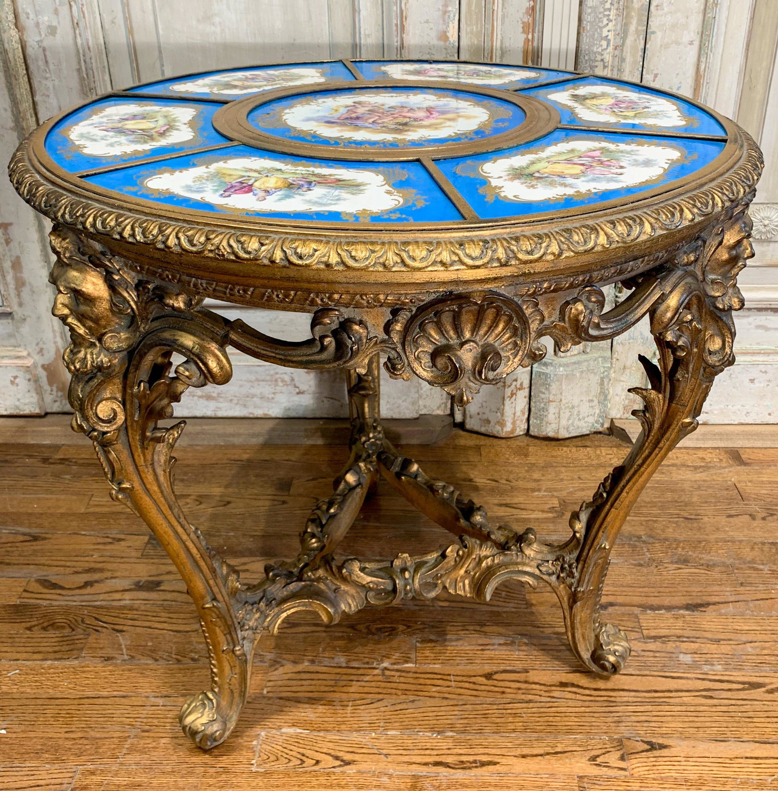 Rare And Important Sevres Style Plaque Table: the top having 7 French Sevres style painted plaques, including a large center plaque, all with classical depictions, the top set on a French Louis XV rococo gilt wood table base; circa 1880; excellen