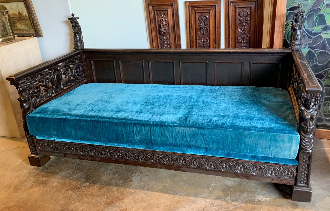Carved Walnut Daybed with Blue Velvet Upholstery: Mattress and 2 bolsters included. Mattress sits on custom upholstered base. Good antique condition. Italian, 19c. 36 deep by 32 high by 82 long. Mattress is 35 x 75 and finials add an extra 13 1/2 inc