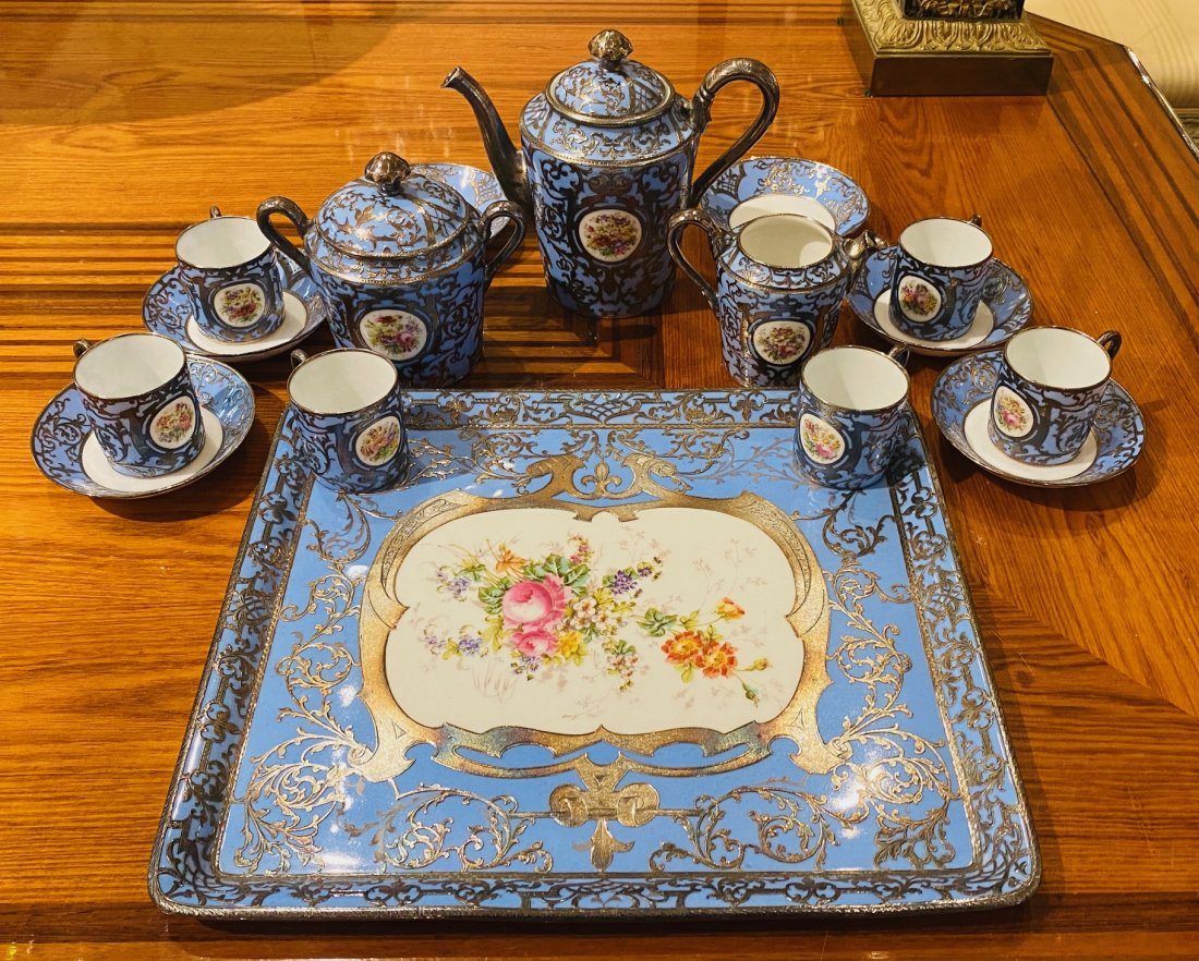 Nice repousse and porcelain tea service: 16 pieces total, no marks. See photo for one small chip, otherwise good condition.