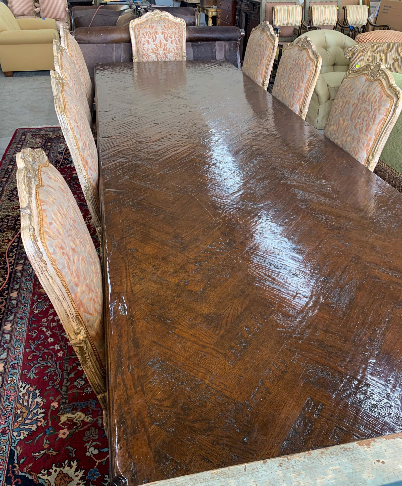 Extraordinary French Style Oak Dining Table: Superb custom quality with parquet top 13ft long x 51 wide x 30 high. Has two extension leaves, each 24 inches. Profile of leaves is carved to match profile of table edge allowing up to 17 feet of din