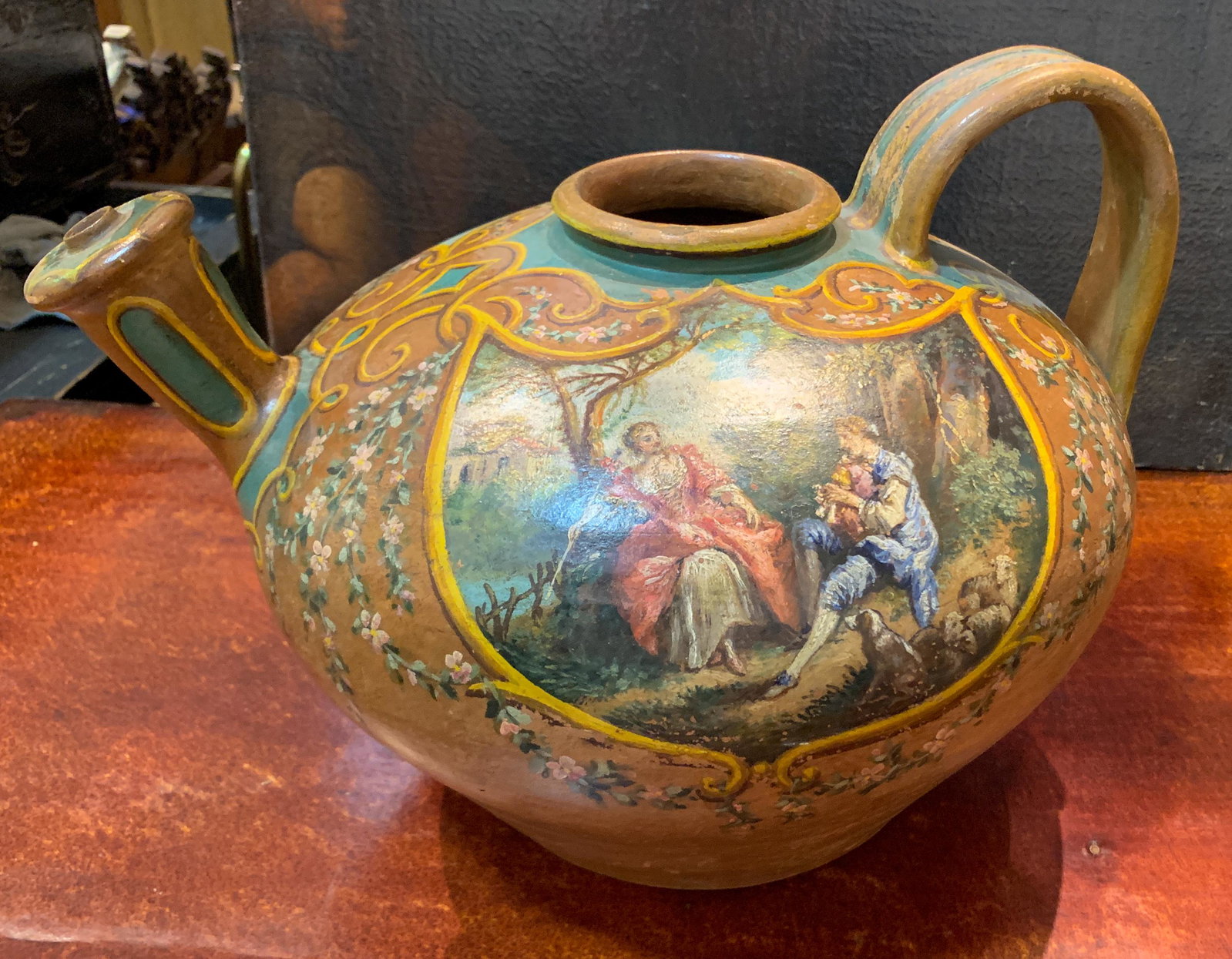 Unusual French Terra Cotta Watering Pitcher: With hand painted romantic scenes; 19th c. 11 h x 17 w x 14 dia