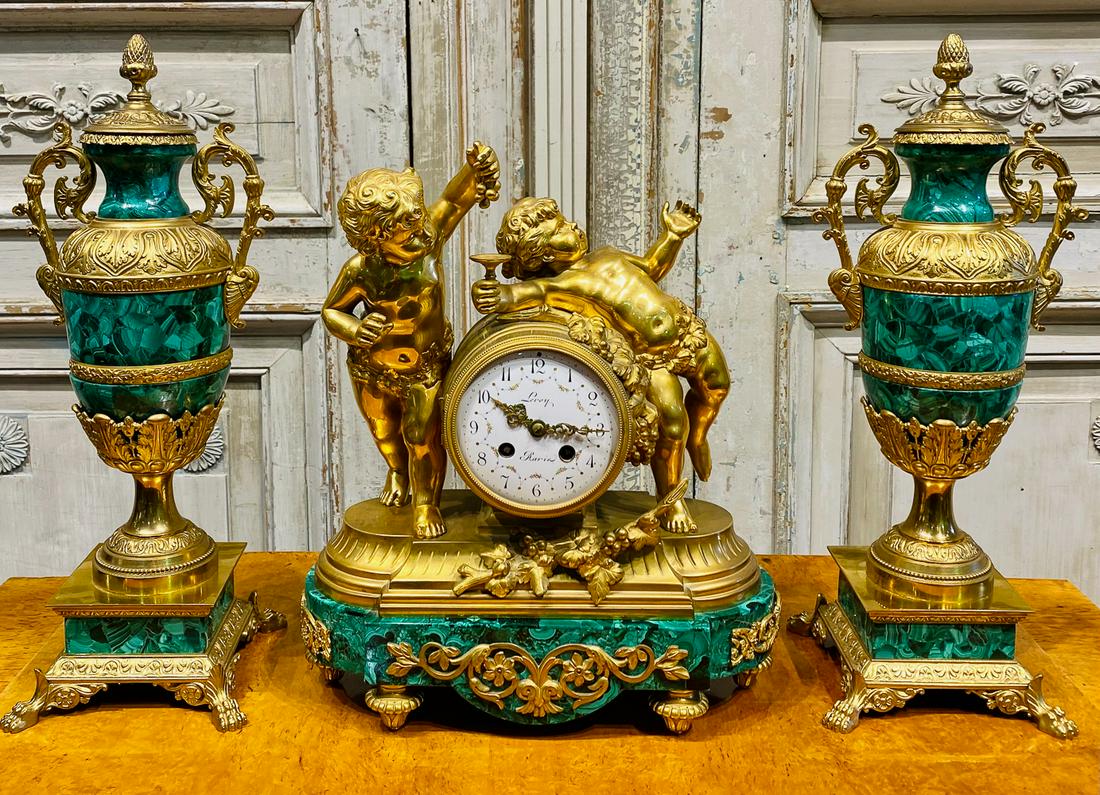 19th C. French Bronze And Malachite Garniture: Clock With Pair Of Lidded Urns. Urns 18 Inches High, Clock 15 X 12.5 X 6. See Photos For Overall Good Condition. Clock Parts Are Not Guaranteed. Assume Clock Will Need To Be Serviced And Is Not In Wor