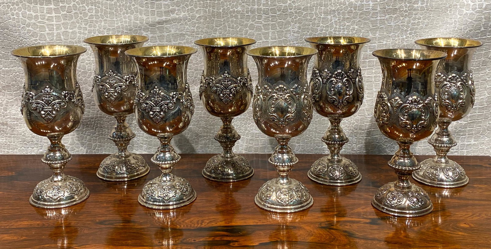 8 Silver Goblets in the French Style: 4 Each Of 2 Complementary Patterns, With Appliqued Designs. 9 Inches High. 347.2 And 335.2 Grams Each. These Tested Silver, But Actual Content is Unknown And Will Need To Be Assessed By Bidder.