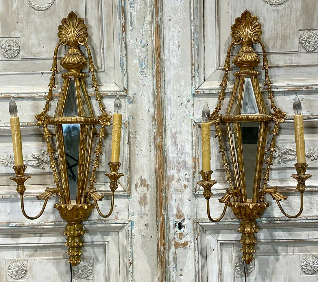 Pair Of Italian Giltwood And Mirrored Sconce: 33.5 High, Arms Adjust 12-17 Wide. Depth 7-8 Inches. See Photos For One Small Crack To Mirror. Each sconce's side swag has previous repairs and is very fragile. Working When Photographed, But Wiring N