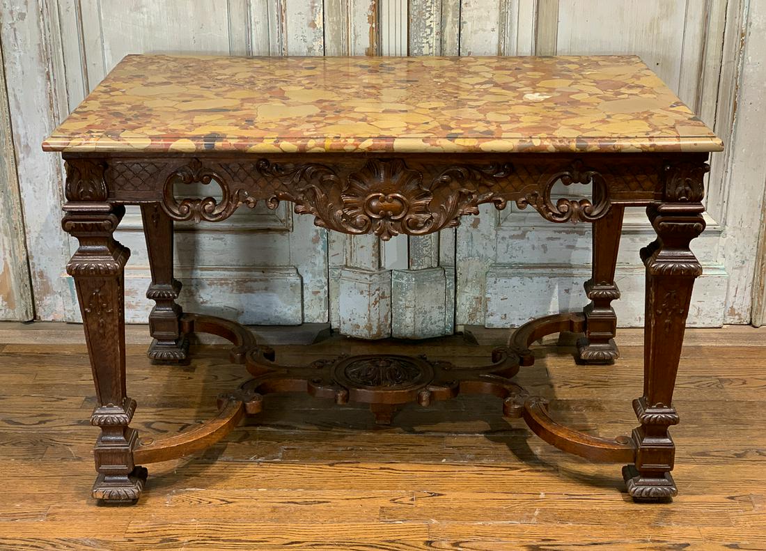 French Carved Walnut Center Table: 20th Century With Breche Marble Top. 47w X 29d X 30h. Inspect Photos For Good Antique Condition And Slight Losses. One Chip to Corner of Leg and Scuffs Commensurate With Age.