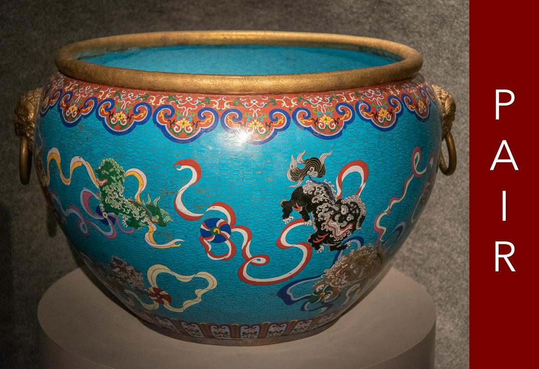 A Pair Of Massive Cloisonne Enameled Cisterns: Planters / Jardiniere Decorated With Buddhist Lions Upon A Turquoise Ground. Cauldrons Each With Turquoise Interiors. Very Good Condition For Age. Opening is 29 inches with widest point measuring 40 i