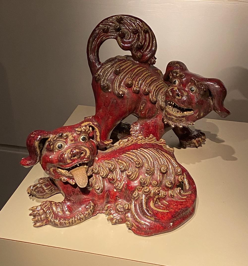 A Pair Of Antique Terracotta Foo Dogs: In Oxblood Glazed And Unglazed Terracotta. Good Condition. Standing Dog is 9 high x 10 wide.