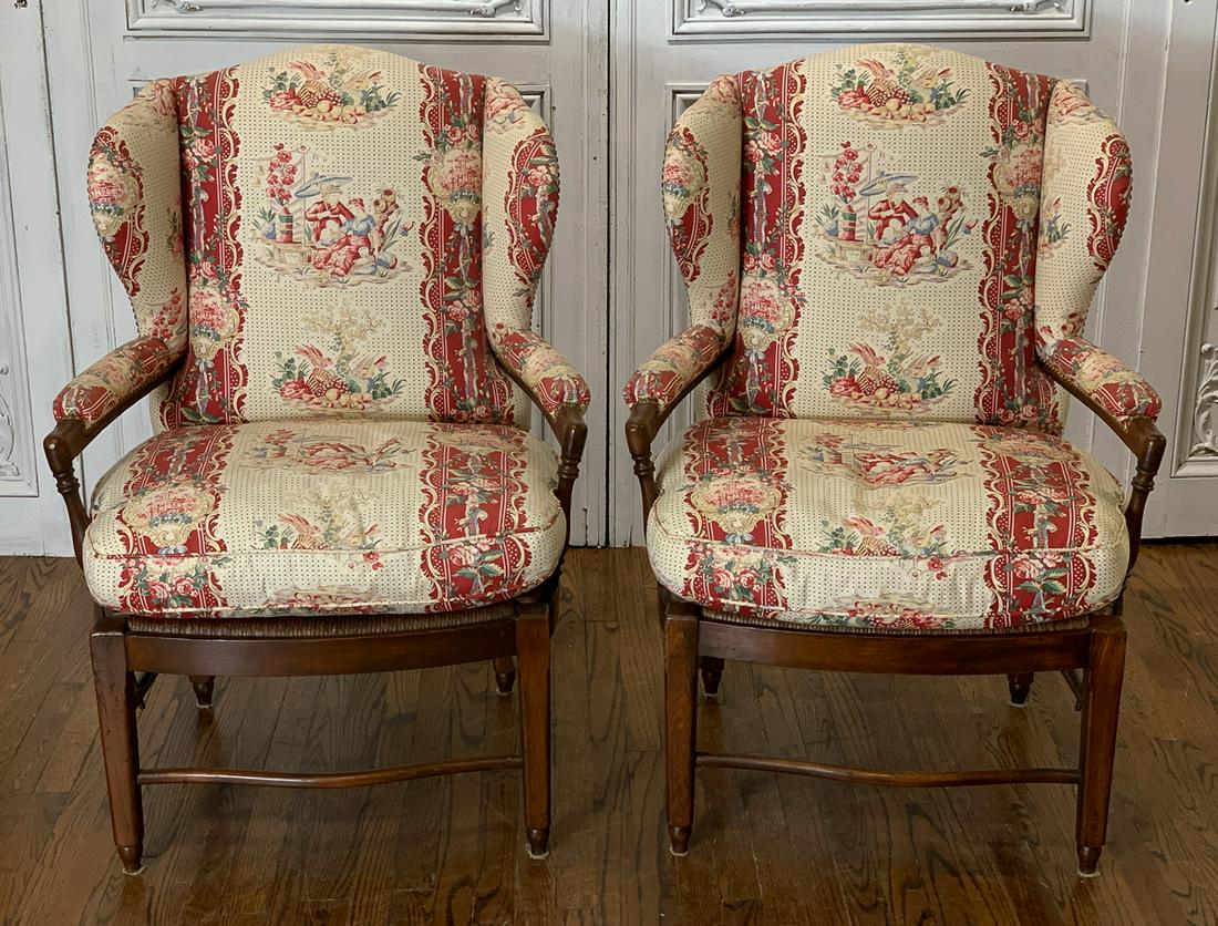 Pair Of French Style Wingback Armchairs: With custom upholstery. Each 29.5w x 43h x 27d. Seat 21.5h. 20th century. Some fading to upholstery on backs of chairs. See photos for condition.