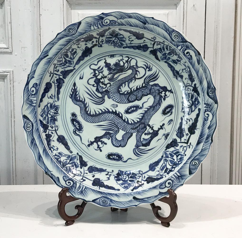Large Chinese Blue And White Pottery Charger: 21st Century, Red Clay Body, Scallop Edge With Waves And Dragon, Height 2.5 Diameter 22 Inches. Includes Stand. See Photos For Condition. Full Report Available On Request.