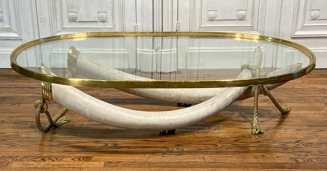 Italo Valenti Bronze Faux Tusk Cocktail Table: 21st Century, Stamped, Oval Galleried Glass On Two Cast Composite Resin Tusks With Trompe L Oeil Rope Mounts In Bronze, Height 16.5 Length 70 Depth 39 Inches. Some Scuffs And Wear To Brass Rim Of Tabl
