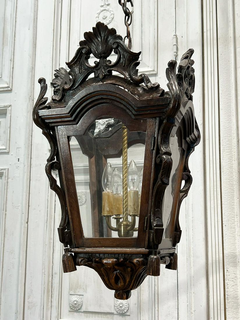 Rococo Style Carved Wood Lantern: 21st Century, Four Lights, Foliate Crest, Tapering Glazed Panels, Ribbon Stiles, Acanthus Pendant, Height 24, Width 14 Depth 14 Inches, Electrification Present But Function Not Guaranteed, 1 Cartouche