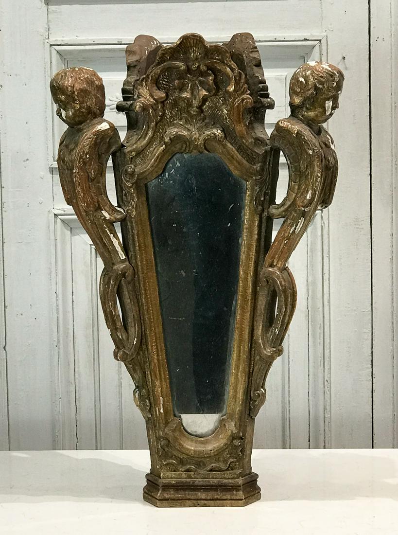 Italian Rococo Giltwood Finial: 18th Or 19th Century, Three Putto Terms Flanking Tapering Rocaille Crested Mirror Plates. Height 25.5 Width 16, Depth 16 Inches. Surface Chips, Crazing, And Patina Appropriate For Age, See Photos For 