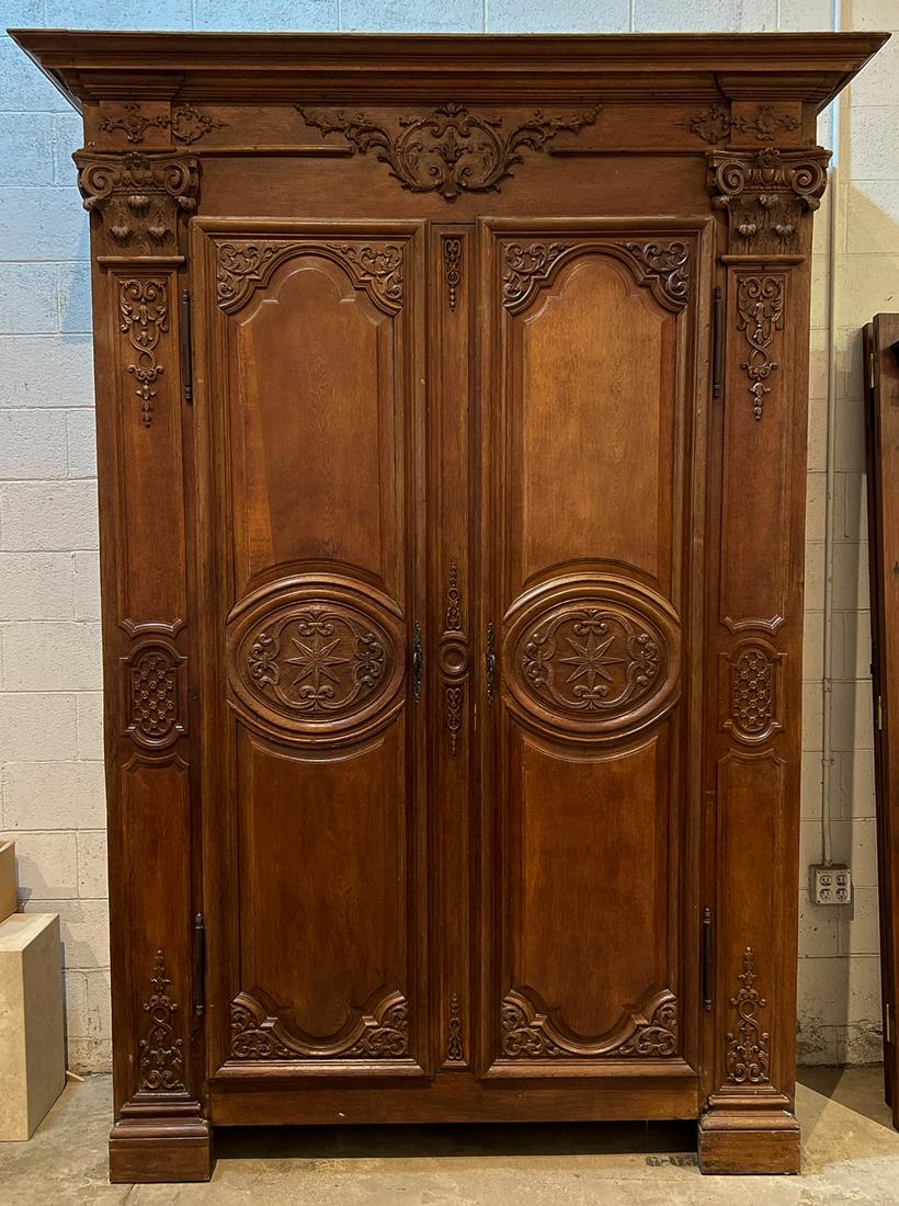 Monumental Louis XVI Style Carved Oak Armoire: 20th Century, Cornice With Carved Frieze, Corinthian Stiles Flanking Two Doors, Interior Fitted With Drawers, Height 105.75, Width 76.5, Depth 27 Inches, See Photos For Additional Condition Informatio