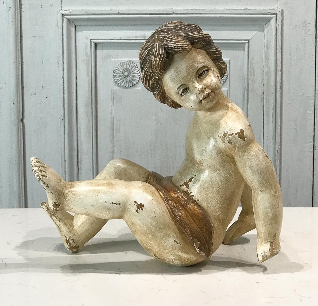 Italian Painted Wood Putto Figure: 20th Century, Probably Walnut, Seated Pose, Gilt Drape, Height 17, Width 6, Depth 7 Inches, Loss Of One Hand, Chipped And Rubbed Surface, See Photos For Additional Condition Information.