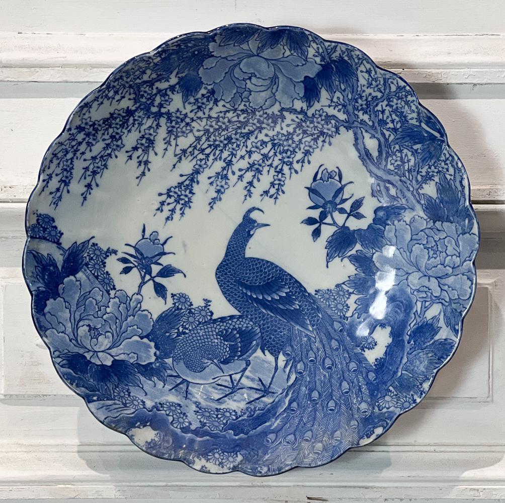 Meiji Blue And White Charger: Japanese, 19th Century, Scallop Edge, Landscape With Peacock Decoration, Diameter 14.25 Inches, Diagonal Non Structural Fissure, Abrasions To Foot, Brass Hanger Affixed To Foot. See Photos For Conditi