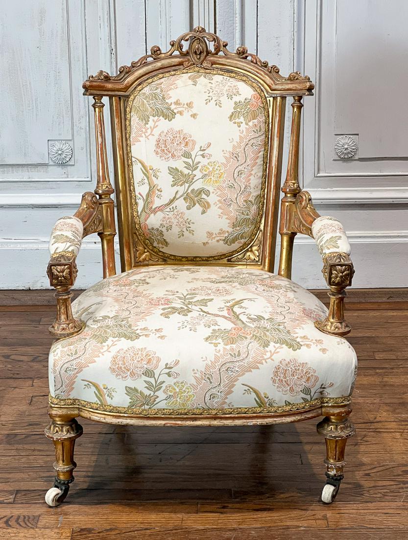 Louis XVI Style Giltwood Fauteuil Armchair: French, 19th Century, Padded Back And Arm Upholstered In Cream, Pink And Green Damask, Later Ceramic Casters, Height 36, Width 26, Depth 30 Inches, Height 16 Inches, Aged Gilt Finish With Loss Consist