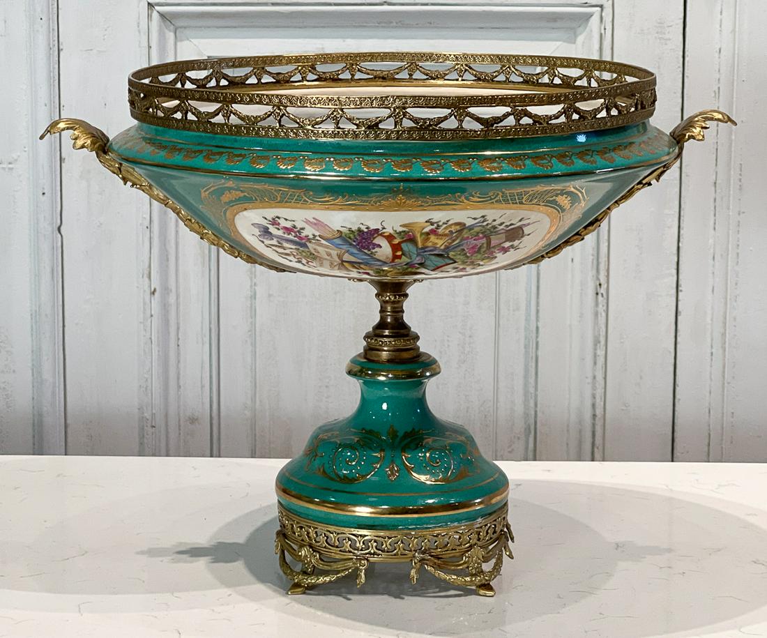 Sevres Style Porcelain Centerpiece: 20th Century, Gilt Bronze Mounts, Green Ground, Musical Trophies In Reserve, Pseudo Mark Underside, Height 14, Width 19, Depth 16 Inches, Light Rubbing, See Photos For Additional Condition Information