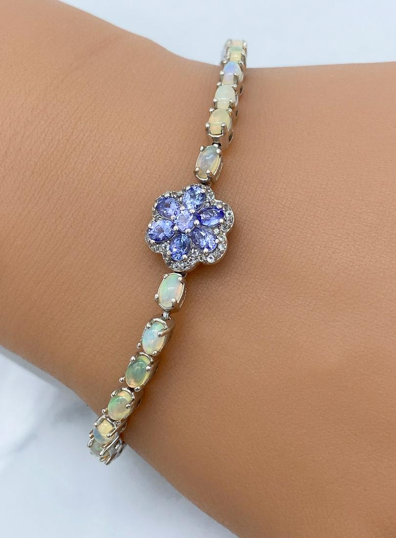 Opal And Tanzanite Bracelet: With White Sapphires Set In Silver. Free-Spinning Flower Set In Silver. See Photos For Additional Condition Information. Wire Transfer Or In-Person Cashier's Check Required For All Jewelry In This Auc