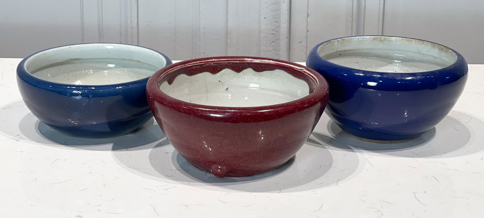 Three Sang De Boeuf And Blue Incense Bowls: Chinese, Probably 20th Century, All With Earthenware Bodies, White Glaze Interiors, Three Feet, Sang De Boeuf 4 X 8.5 X 8.5 Inches, All With Crazing Craquelure And Glaze Loss On Underside