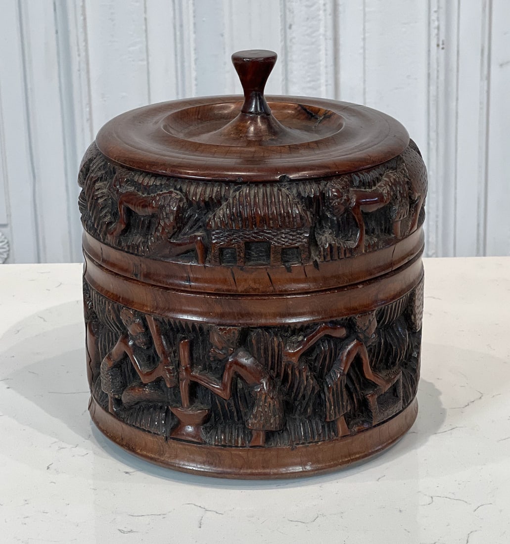 African Carved Hardwood Humidor Box: 20th Century, Knop Handle, Barrel Form With Figures Working In A Village Carved In Bas Relief, 8 X 8 X 8 Inches, Small Natural Shrinkage Fissures And Scratches To Surface