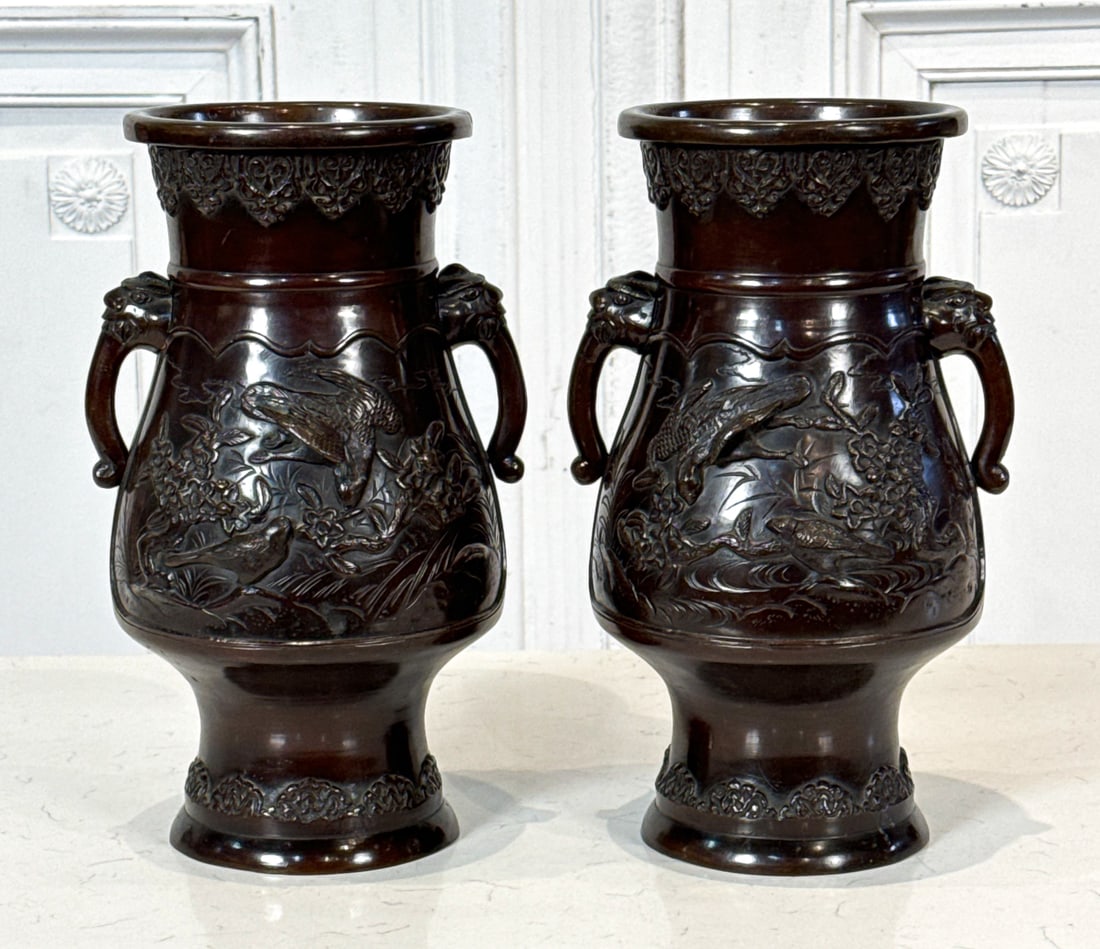 Pair Japanese Bronze Urns: Pair Japanese Bronze Urns, Probably 20th Century, Each Marked Underside, Elephant Handles, With Birds In Low Relief, Height 13.5 Inches. See Photos For Additional Condition Information.