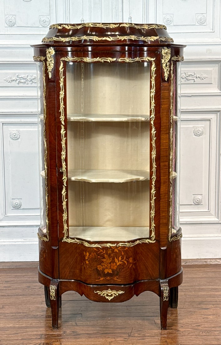 French Bronze Mounted Inlaid Mahogany Vitrine: French Bronze Mounted Inlaid Mahogany Vitrine, Early 20th Century, In The Louis XV Style, Serpentine Case With Stepped Cornice, Curved Glass, Shelved Floral Marquetry Panel, Saber Front Legs, Height 6