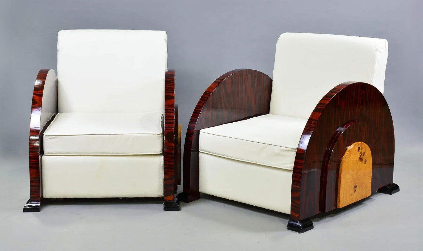 Pair Of Art Deco Style Club Chairs: Pair Of Art Deco Style Club Chairs With White Leather Upholstery. Structurally Sound, Upholstery Intact, But Loose Underside As Shown In Photos. 35w x 30d x 33h. Seat Height 24 Inches. See Photos For