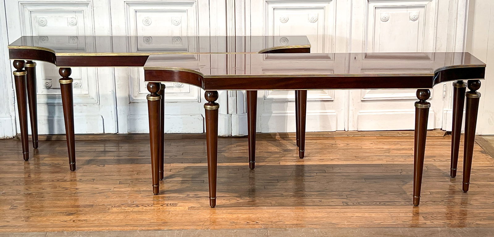 Pair Large Baker Mahogany Console Tables: Pair Large Baker Mahogany Console Tables, American, Late 20th Century, Each With Baker Furniture Plaque Underside, In The Regency Taste With Gilt Trim, Reeded Edges, Spherule Terminals On Tapering Leg