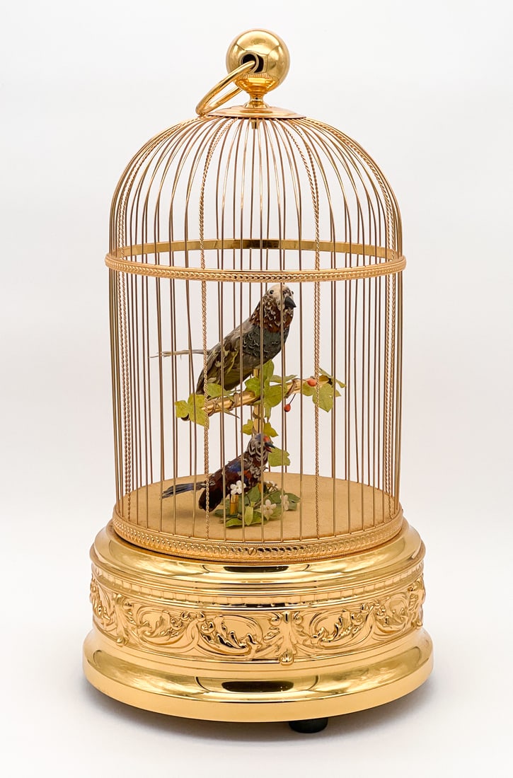 Reuge Music Birdcage Automaton: Reuge Music Birdcage Automaton. Swiss, Late 20th Century, With Two Natural Feather Figures In A Brass Cage, Marked Underside, Height 21, Diameter 12 Inches. One Screw Misthreaded On Base. Lacks Key An