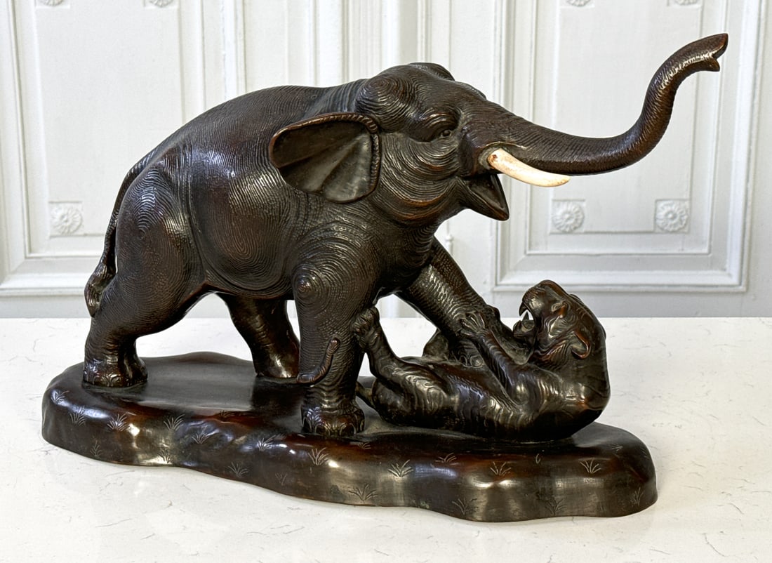 Meiji Bronze Elephant And Tiger Group: Meiji Bronze Elephant And Tiger Group, Japanese, Early 20th Century Elephant With Later Bone Tusks, Elephant Battling A Tiger, Ink Inscribed Underside, Height 13, Length 19, Depth 7 Inches, Later Tusk