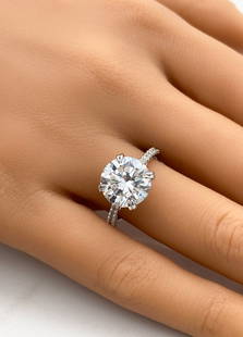 5ct Diamond And 14k White Gold Ring: 5 Carat Brilliant Cut Diamond Set In 14k White Gold. This Ring Is Comprised Of A 5ctw Center Stone Of F Color, Si2 Clarity. Approximately 0.50ctw Diamonds Flank Center Stone. Total Weight 4.4g. Size 7